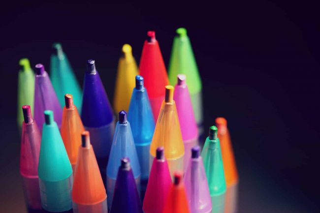 Photo by Alexander Grey multi colored pen lot on black background